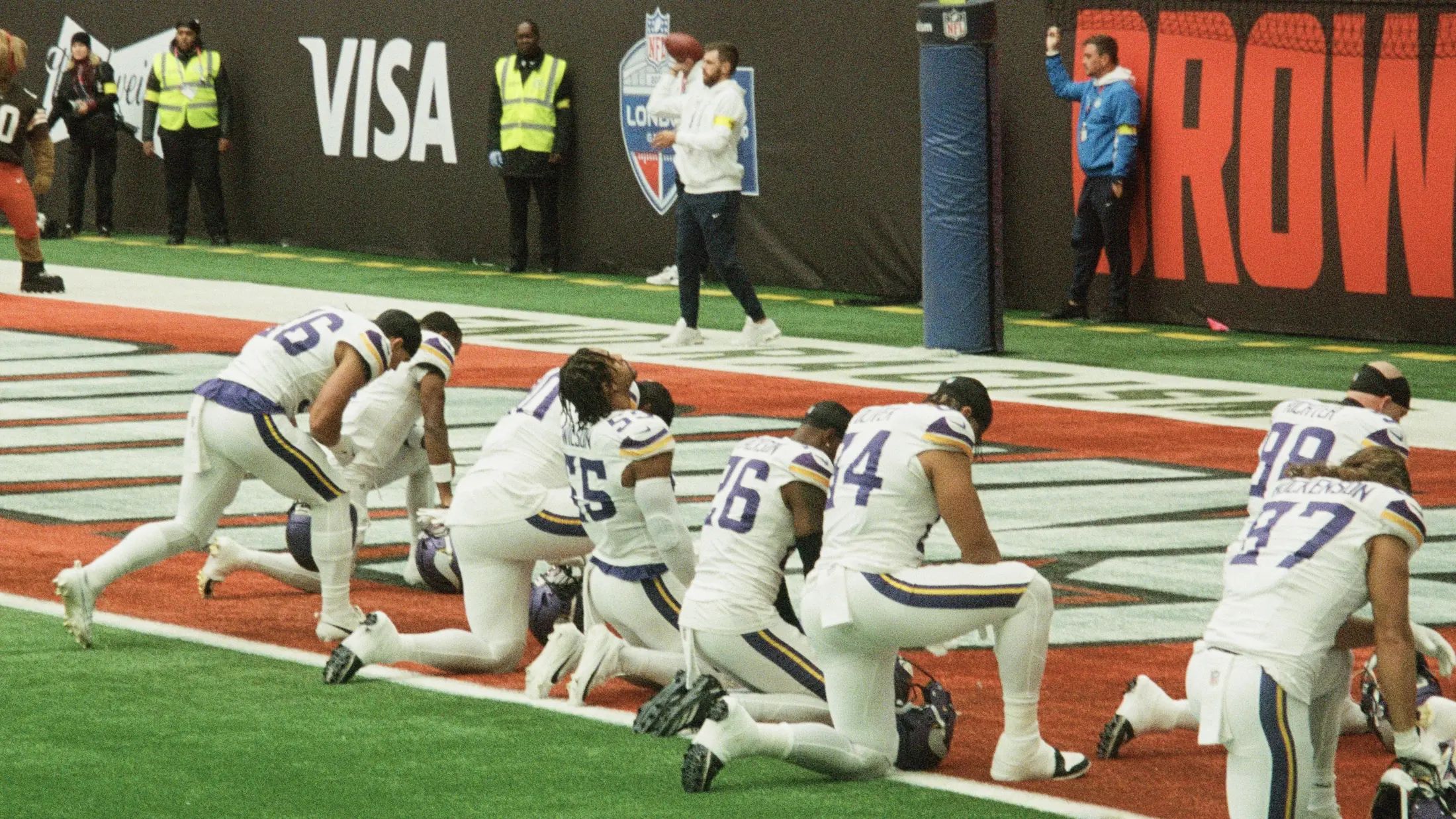 Footballspieler knien vor dem Spiel in der Endzone